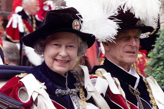 WINDSOR, UNITED KINGDOM: Britain's Queen Elizabeth II and Prince Philip leave by carriage Saint Georges Chapel in Windsor 14 June 1999 after a church service that is part of the Garter ceremony. (Photo credit should read MARTYN HAYHOW/AFP/Getty Images)