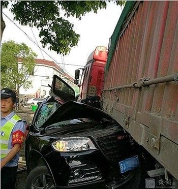 Chiếc xe hơi bị xe container đè bẹp. Ảnh: Sina