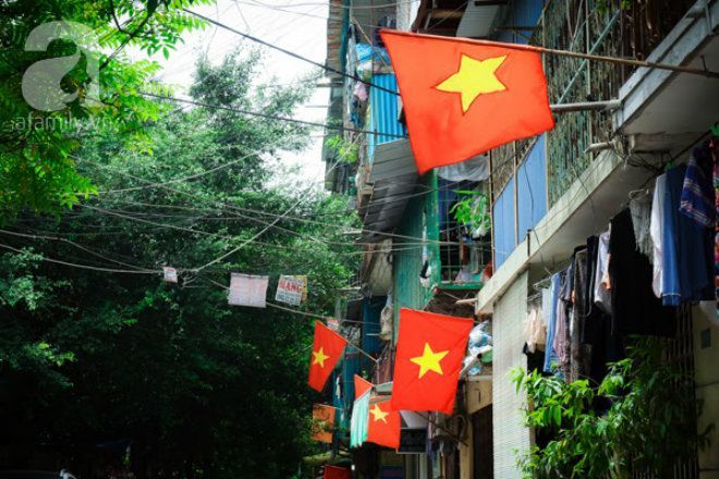 Các hộ gia đình cùng nhau treo cờ Tổ quốc tại một khu tập thể ở Cầu Giấy.