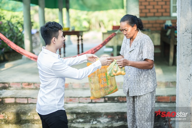 Doanh nhân Minh “nhựa” trao quà cho một người dân trong chuyến thiện nguyện.