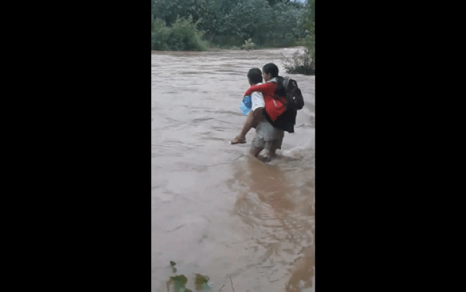 Clip: 'Thót tim' cảnh người cha cõng con gái qua dòng nước xiết sang bên kia sông để kịp giờ đi học Ảnh 2