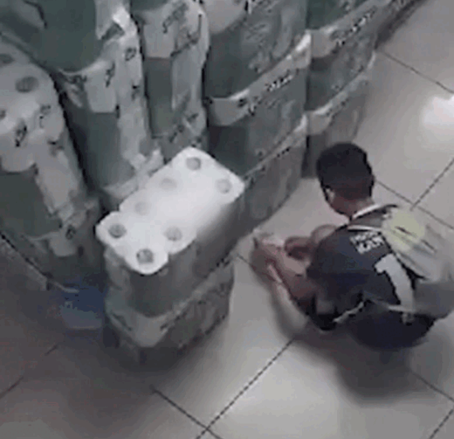 Hình ảnh cậu bé xé nhãn sản phẩm trên kệ và châm lửa bằng bật lửa. (Nguồn: @crusty.left.sock)