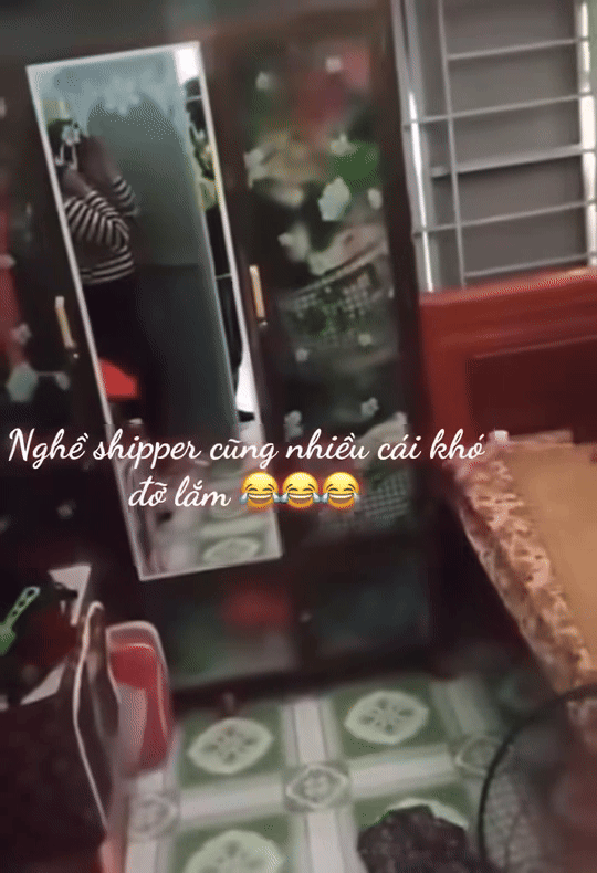 Thấy nam shipper đứng ở ngoài gọi ra nhận hàng, người phụ nữ núp sau cánh cửa phòng ngủ 'chơi trốn tìm', thế nhưng nam shipper đã thấy chị qua phản chiếu của chiếc gương soi. Ảnh cắt từ clip
