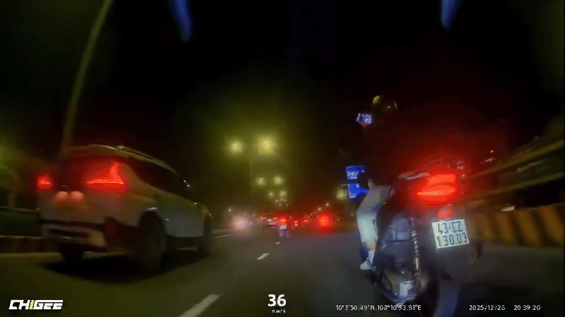 Thanh niên vừa lái xe máy vừa điều khiển điện thoại. Ảnh cắt từ clip/Nguồn: Page Công an TP Đà Nẵng