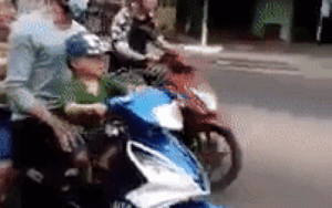 Nam thanh niên chở 2 bé trai không đội mũ bảo hiểm còn giơ 2 tay tạo dáng để bé trai ngồi trước cầm lái gây bức xúc