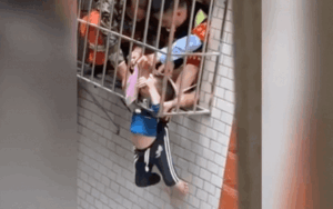 Bé trai 3 tuổi mắc kẹt giữa ban công, cảnh giải cứu thót tim