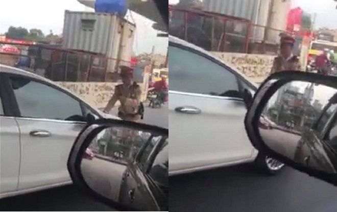 Nữ tài xế nhấn ga đẩy lùi CSGT khi bị yêu cầu dừng xe vì vượt đèn đỏ