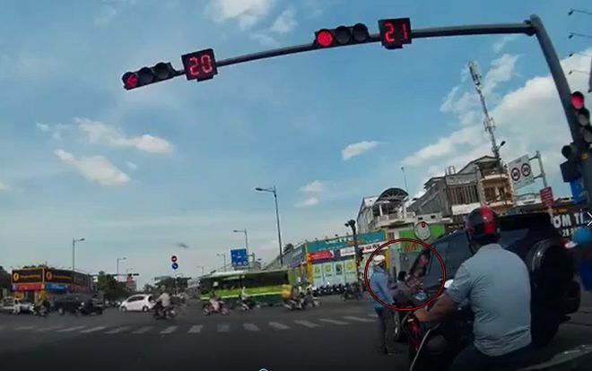 Ô tô liên tục bóp còi đòi vượt đèn đỏ, thanh niên đi xe máy 'nóng mặt' nhảy xuống đường 'dạy dỗ'