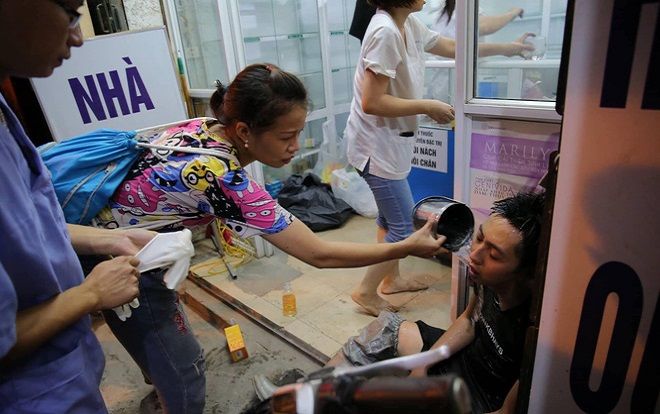 Hình ảnh người phụ nữ vẻ mặt lo lắng, dội nước sơ cứu cho chiến sĩ cứu hỏa hồi tỉnh gây xúc động mạnh