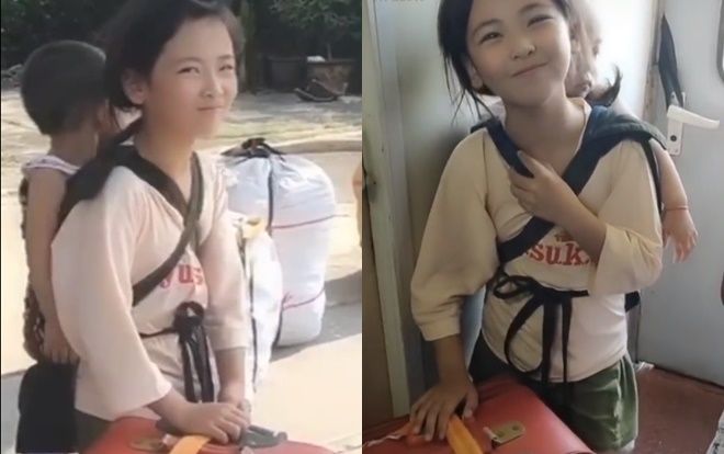 Video bé gái xinh xắn cõng em trên tàu gây sốt mạng xã hội
