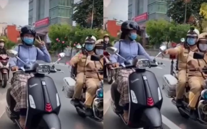 Giơ tay lên chụp ảnh khi đang chạy xe máy, cô gái giật mình khi CSGT xuất hiện yêu cầu tấp vào kiểm tra