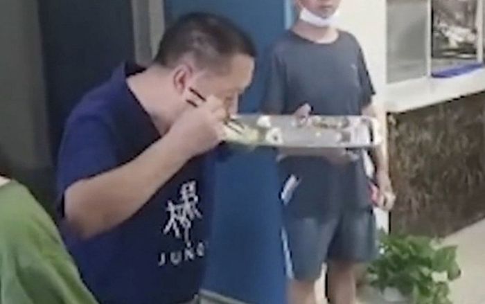 Thầy hiệu trưởng ăn cơm thừa của học sinh gây tranh cãi