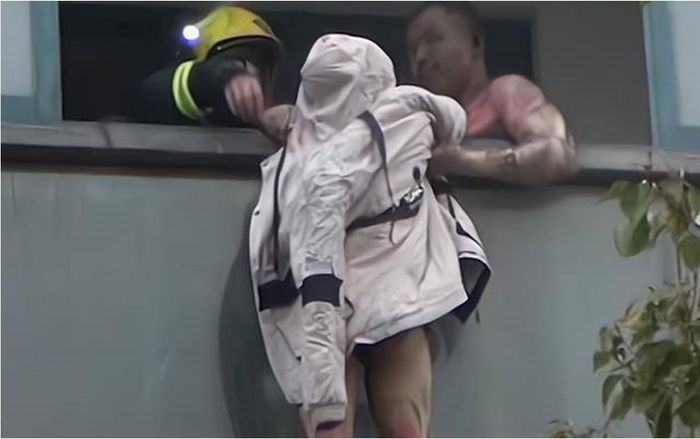 Chồng chịu đau đớn nắm chặt tay vợ ngoài ban công giữa hỏa hoạn