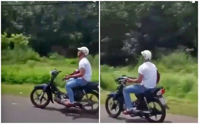 Thanh niên lái xe bằng chân, vừa chạy vừa đánh đàn ghi-ta vì đang đi cảm thấy buồn