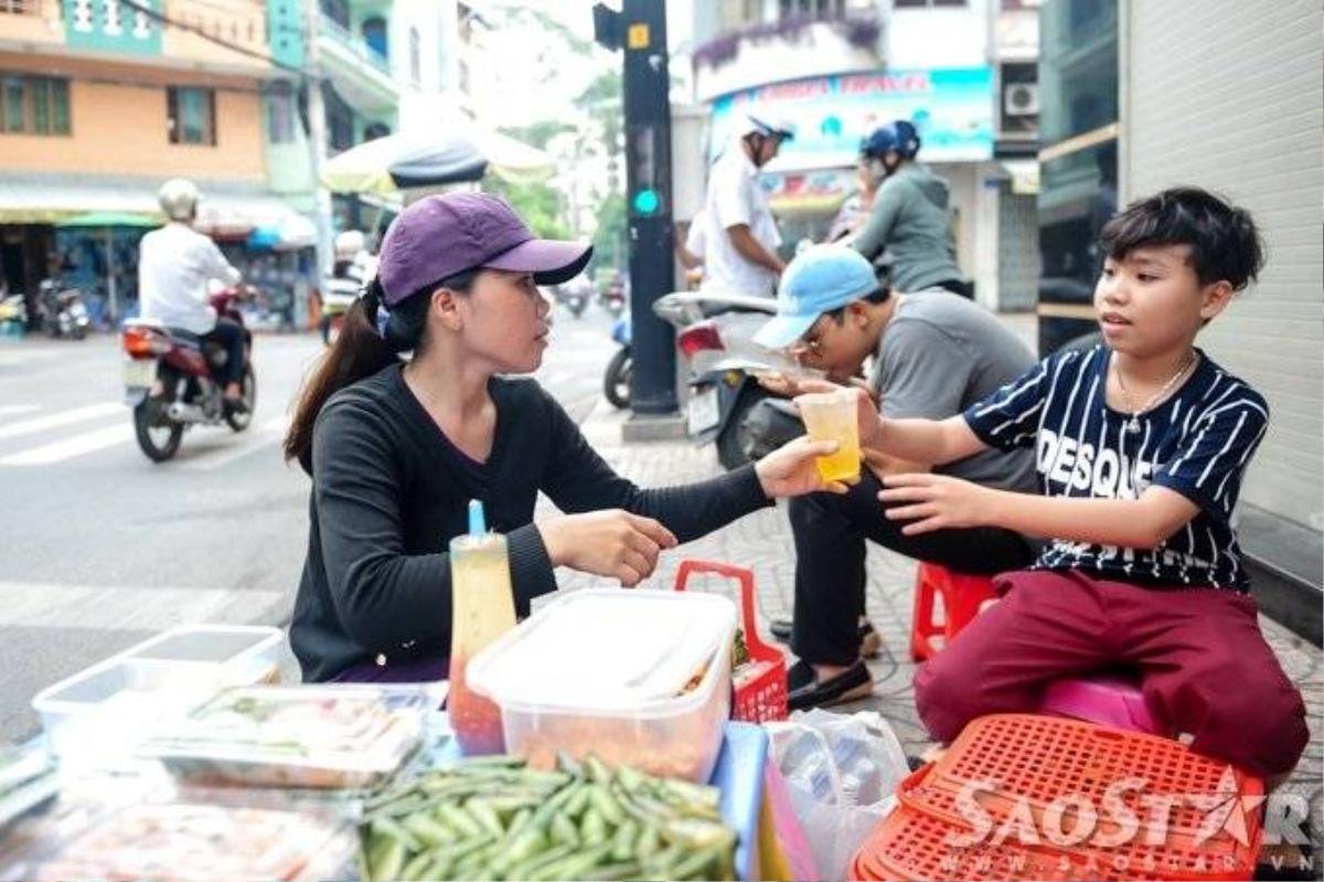 Canh mẹ vừa nghỉ tay, em tranh thủ đưa ly trà đá cho mẹ giải khát. 