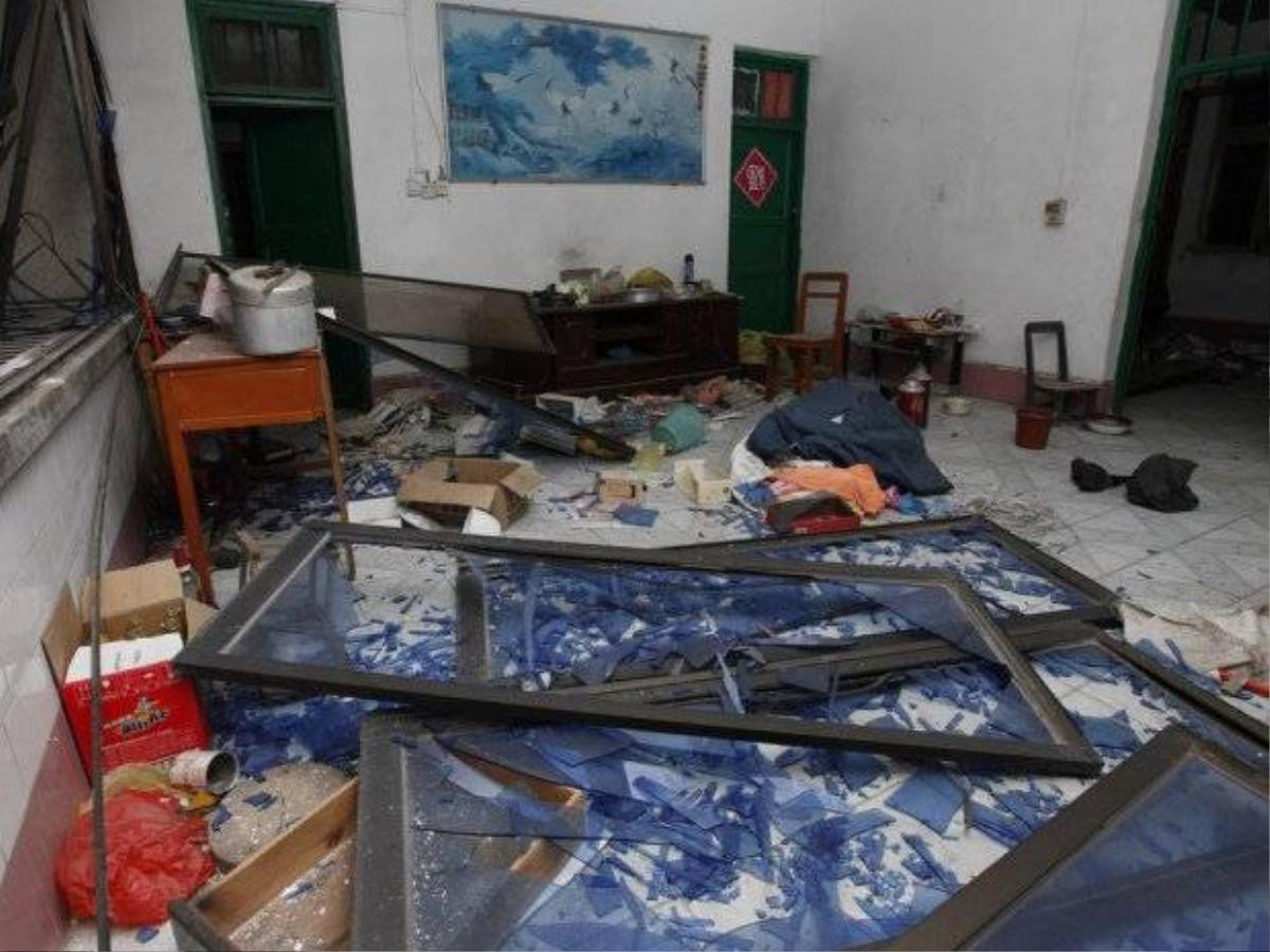 Damaged windows are seen on the ground of a room at the site of blasts in Liucheng county in Liuzhou in south China's Guangxi province on September 30, 2015. Three people were killed on September 30 by multiple explosions in southern China, state media said, with local reports saying that the blasts occurred in 13 locations including government offices. CHINA OUT AFP PHOTO / STRSTR/AFP/Getty Images