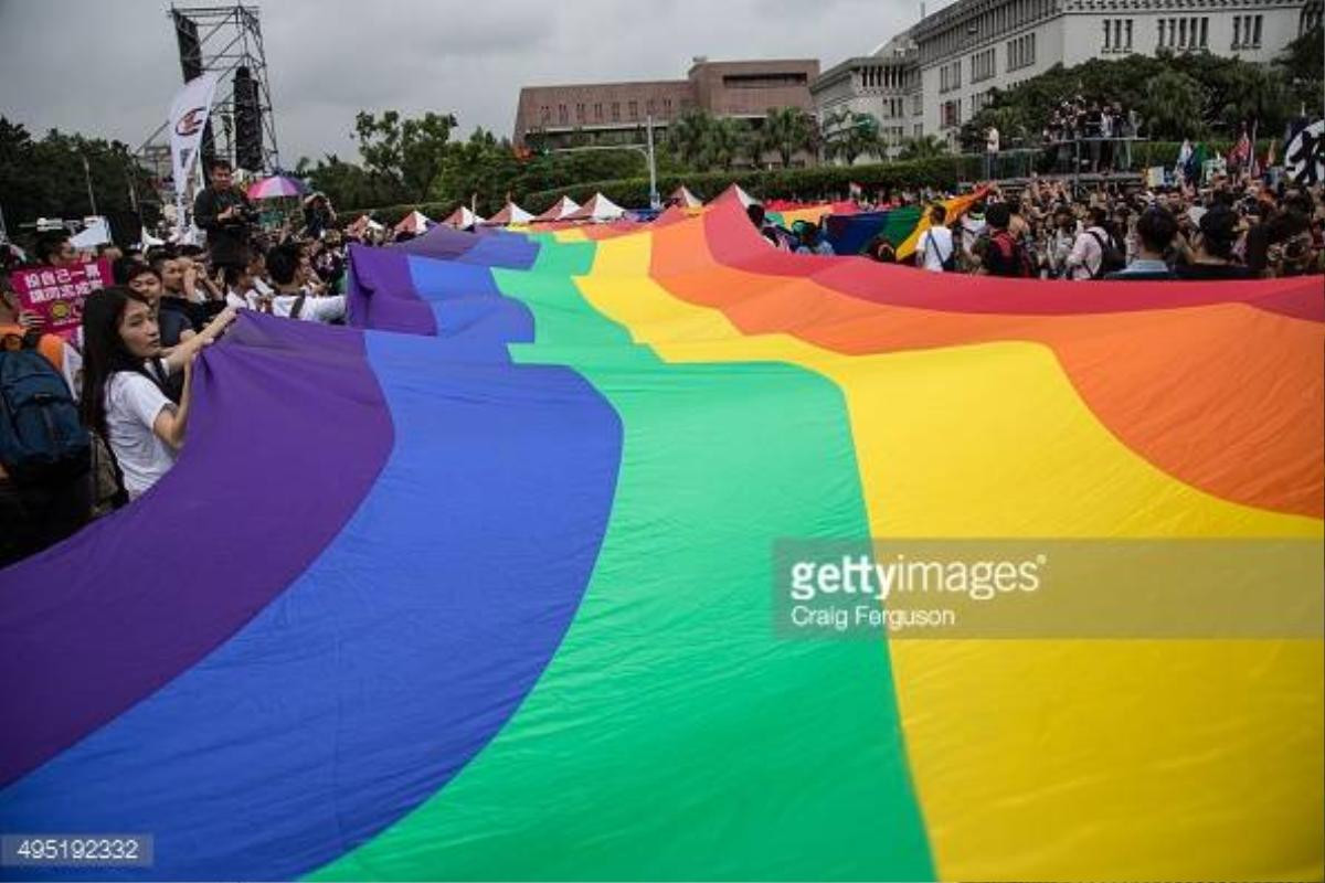 TAIPEI, TAIWAN - 2015/10/31: The rainbow flag, a symbol of gay rights, leads off the annual LGBT pride march. Upwards of 60 000 people took to the streets of Taipei for the annual Pride march, the largest such event in Asia. Taiwan is often said to be the likeliest Asian nation to legalize gay marriage. (Photo by Craig Ferguson/LightRocket via Getty Images)