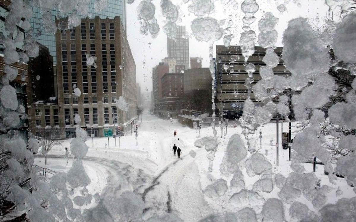 21 People walk through snow-covered Copley Square during a blizzard in Boston, Massachusetts