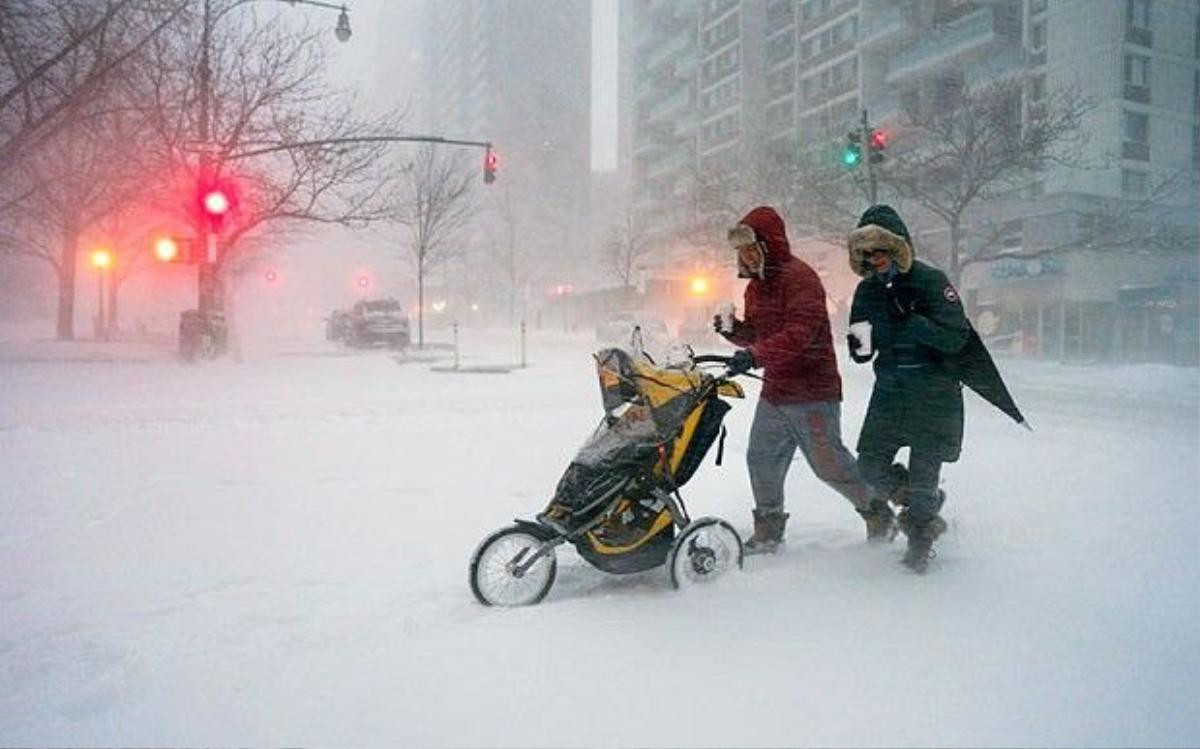 3 jonas Sean Jackson and Gina Del Tatto push their child, Hayes Jackson, in a stroller as heavy snow falls in New York's Upper West Side