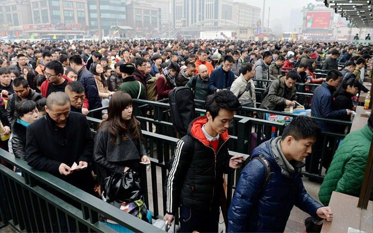 Mandatory Credit: Photo by Imaginechina/REX (4434659c) Crowds of passengers flock into Beijing Railway Station Travel rush ahead of the Chinese New Year, China - 16 Feb 2015 Planes, trains, automobiles, even motorcycles, whatever the transport option, it's bursting at the seams. Hundreds of millions of mainland Chinese are now embarking on the world's largest annual human migration, squeezing in up to 2.8 billion trips to visit friends and family over the Lunar New Year holiday. Official government figures predict 2.4 billion road, 295 million rail and 47.5 plane journeys will be taken over the 40-day travel rush between February 4 and March 16.