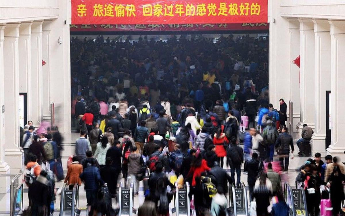 Mandatory Credit: Photo by Imaginechina/REX (4434659e) Crowds of passengers flock into Hankou Railway Station in Wuhan city, Hubei province Travel rush ahead of the Chinese New Year, China - 16 Feb 2015 Planes, trains, automobiles, even motorcycles, whatever the transport option, it's bursting at the seams. Hundreds of millions of mainland Chinese are now embarking on the world's largest annual human migration, squeezing in up to 2.8 billion trips to visit friends and family over the Lunar New Year holiday. Official government figures predict 2.4 billion road, 295 million rail and 47.5 plane journeys will be taken over the 40-day travel rush between February 4 and March 16.