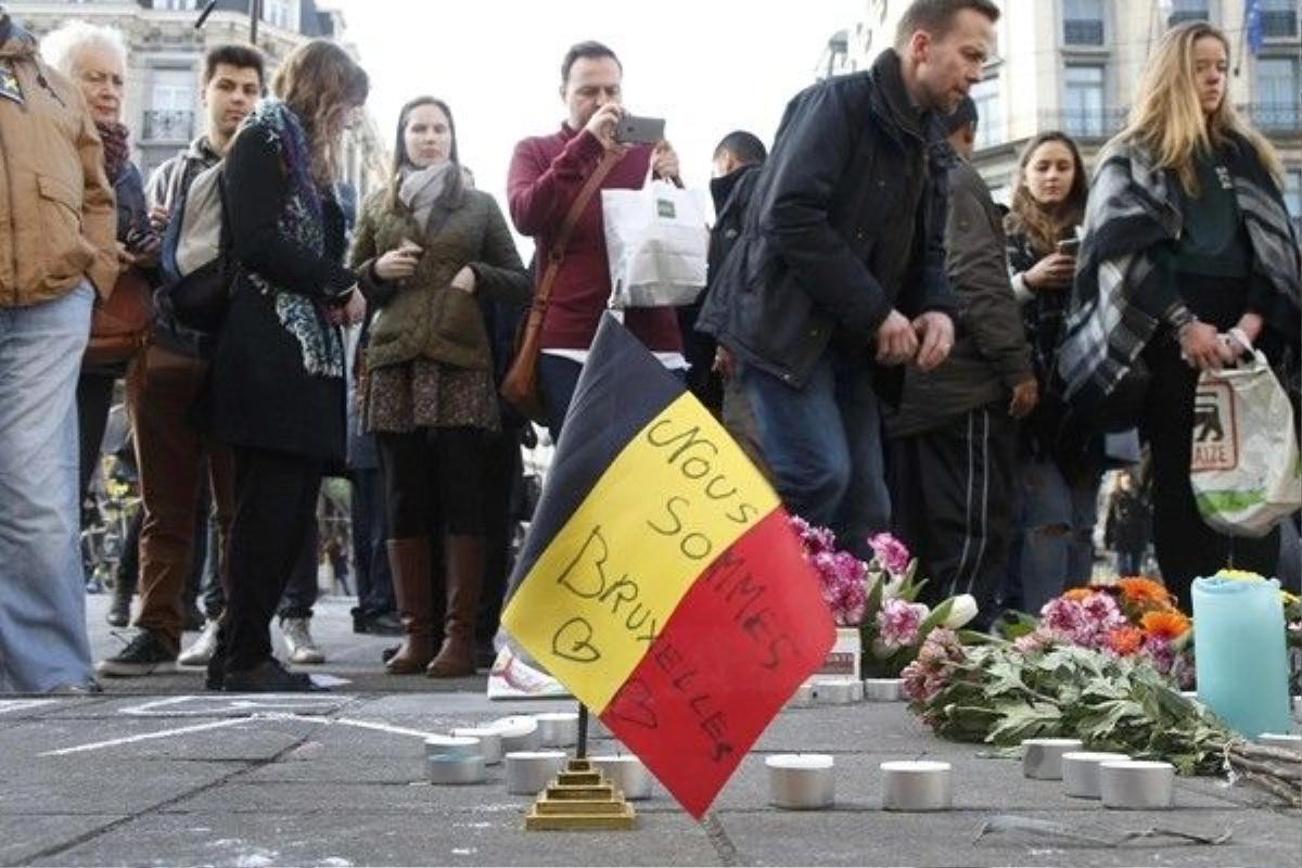 People gather around a memorial in Brussels following bomb attacks in Brussels, Belgium