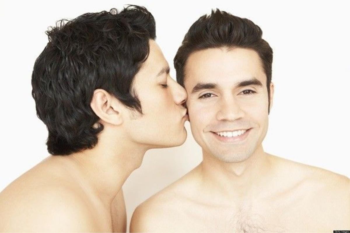 Shirtless gay couple kissing