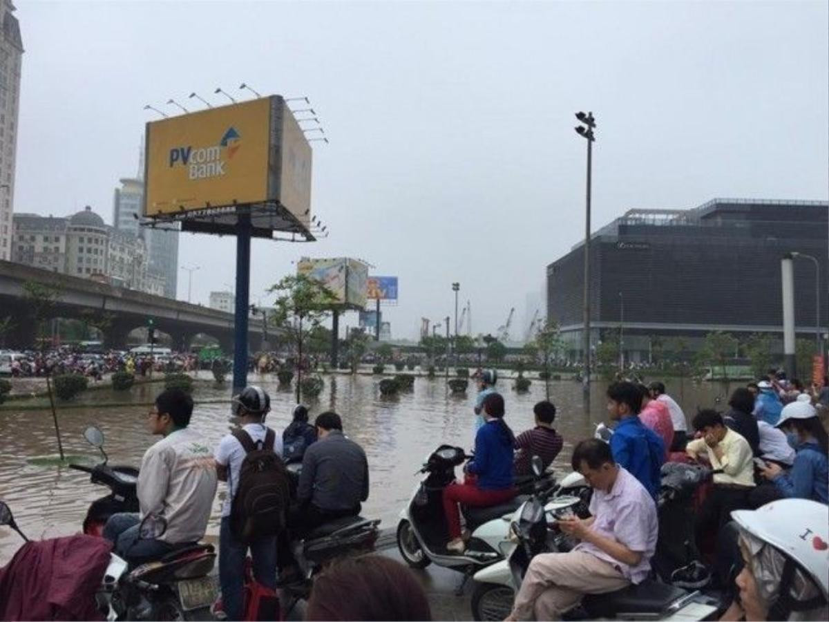 Người dân chỉ còn biết ngồi trước tòa nhà Keang Nam, hy vọng nước sẽ xuống nhanh để họ có thể tiếp tục di chuyển.