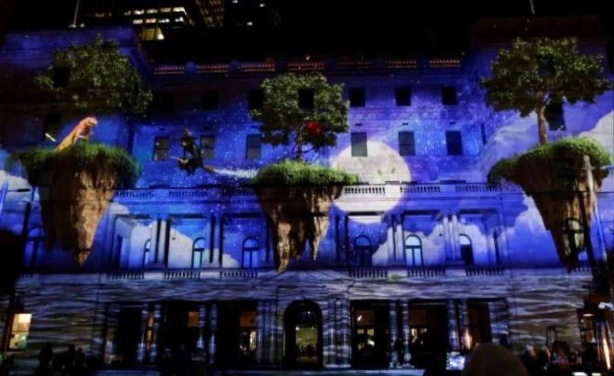 An animated film featuring a lizard and a witch on floating islands is projected onto Sydney's Customs House during the opening night of the annual Vivid Sydney light festival in Sydney, Australia May 27, 2016. REUTERS/Jason Reed - RTX2EHNC