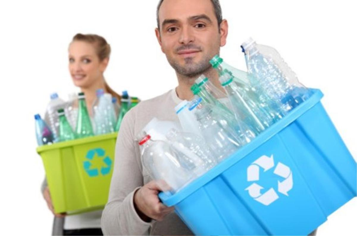 Man and woman recycling plastic bottles