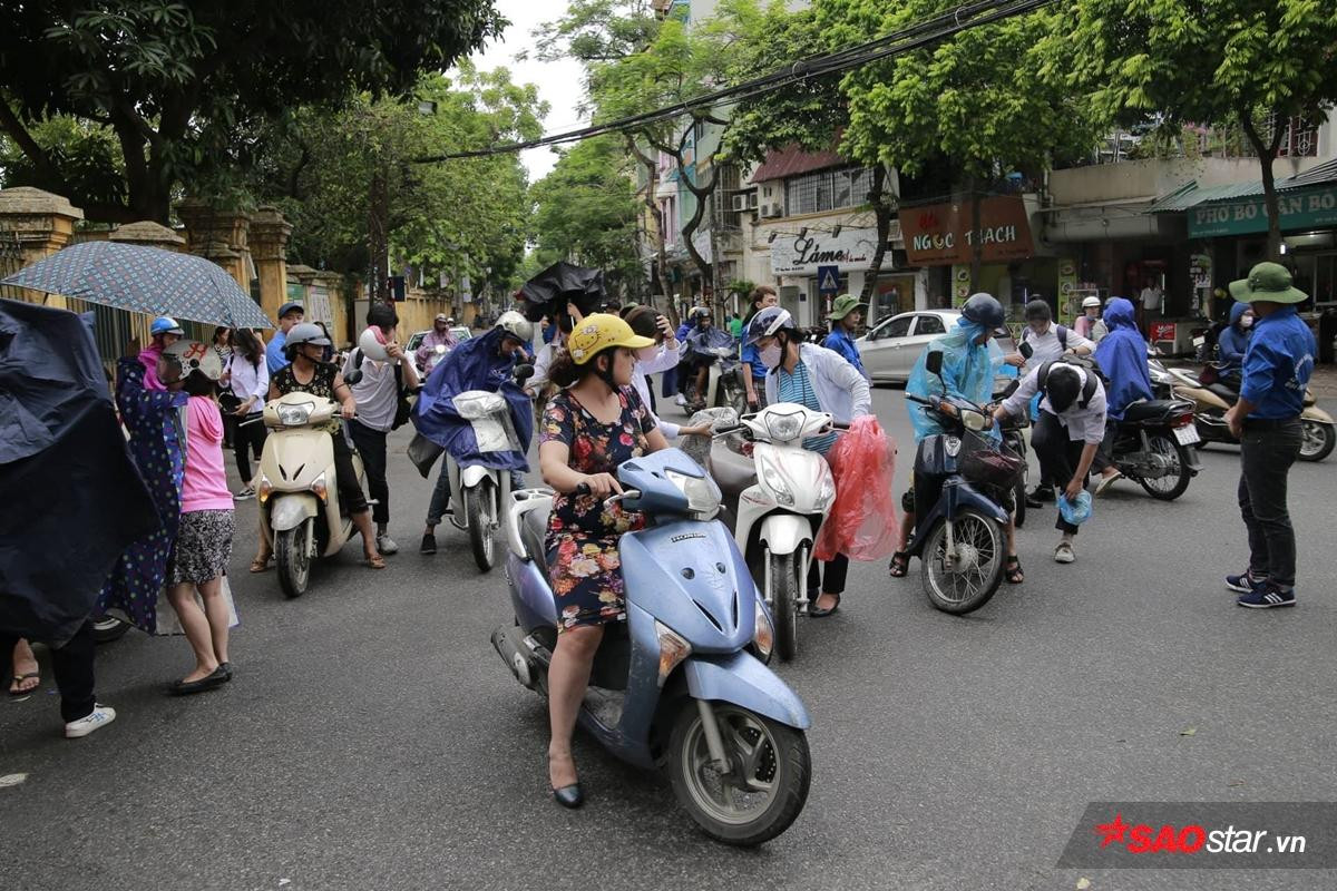 Hà Nội đổ mưa như càng chứng tỏ tấm lòng đẹp của sinh viên tình nguyện: Mặc người ướt vẫn nhường ô, áo mưa cho sĩ tử dự thi Ảnh 10