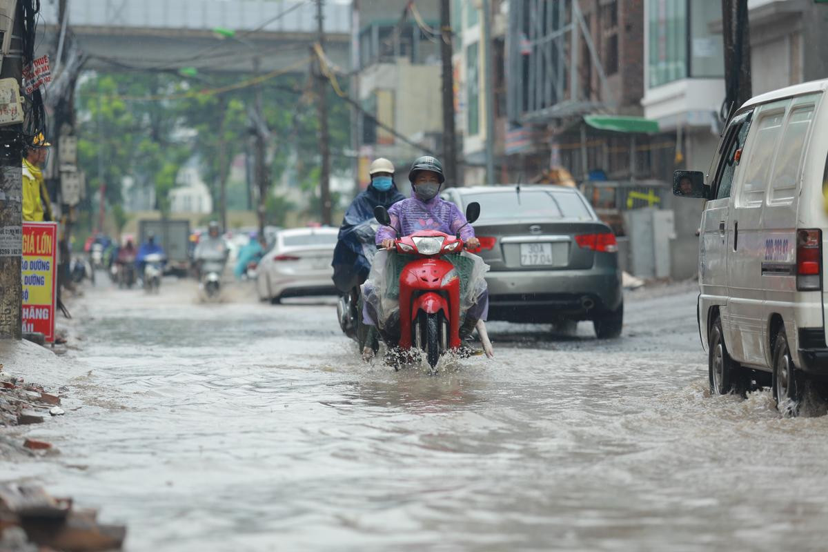 Mưa lớn khiến nhiều tuyến đường Hà Nội chìm trong 'biển nước', người đi xe máy ngã lăn ra đường Ảnh 2