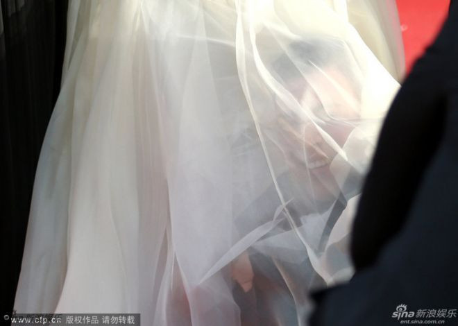 CANNES, FRANCE - MAY 16: A man sneaks under America Ferrera's dress at the "How To Train Your Dragon 2" premiere during the 67th Annual Cannes Film Festival on May 16, 2014 in Cannes, France. (Photo by Andreas Rentz/Getty Images)