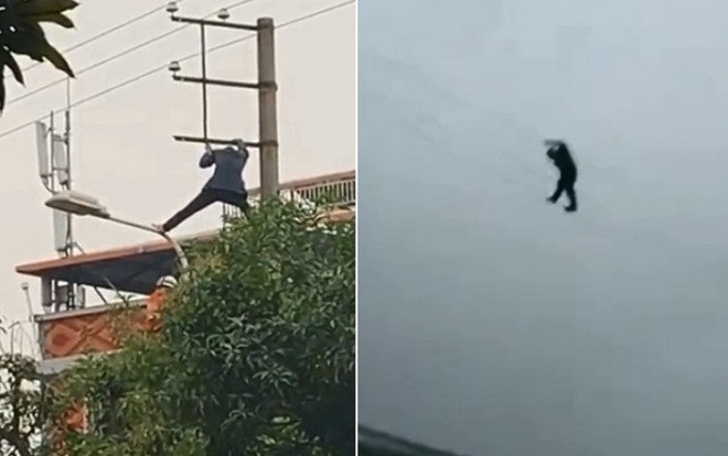 Người đàn ông say rượu trèo lên cột cao thế, đu dây điện như biểu diễn xiếc Ảnh 2
