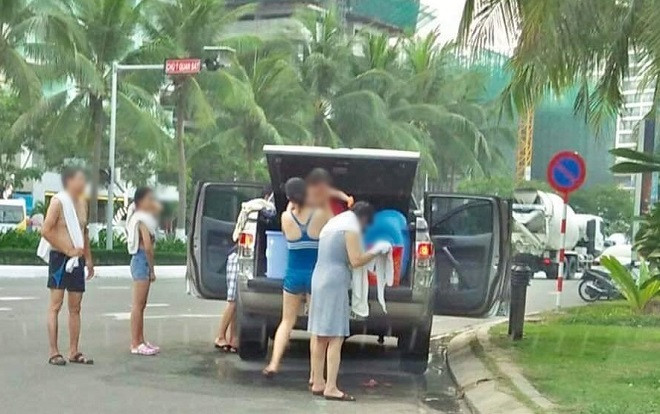 Đỗ ô tô dưới lòng đường, cả gia đình thản nhiên lập 'phòng tắm di động' ngay trên đường phố Đà Nẵng Ảnh 2