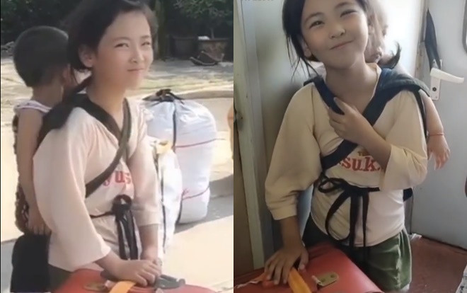 Video bé gái xinh xắn cõng em trên tàu gây sốt mạng xã hội Ảnh 2