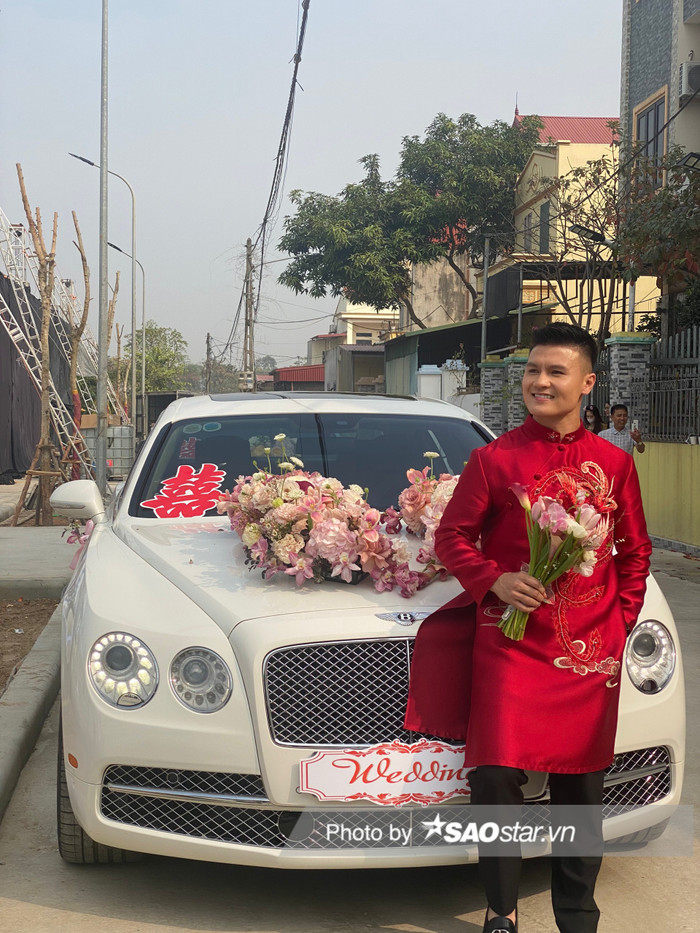 Chú rể Quang Hải bảnh bao với áo dài cách tân màu đỏ nổi bật.