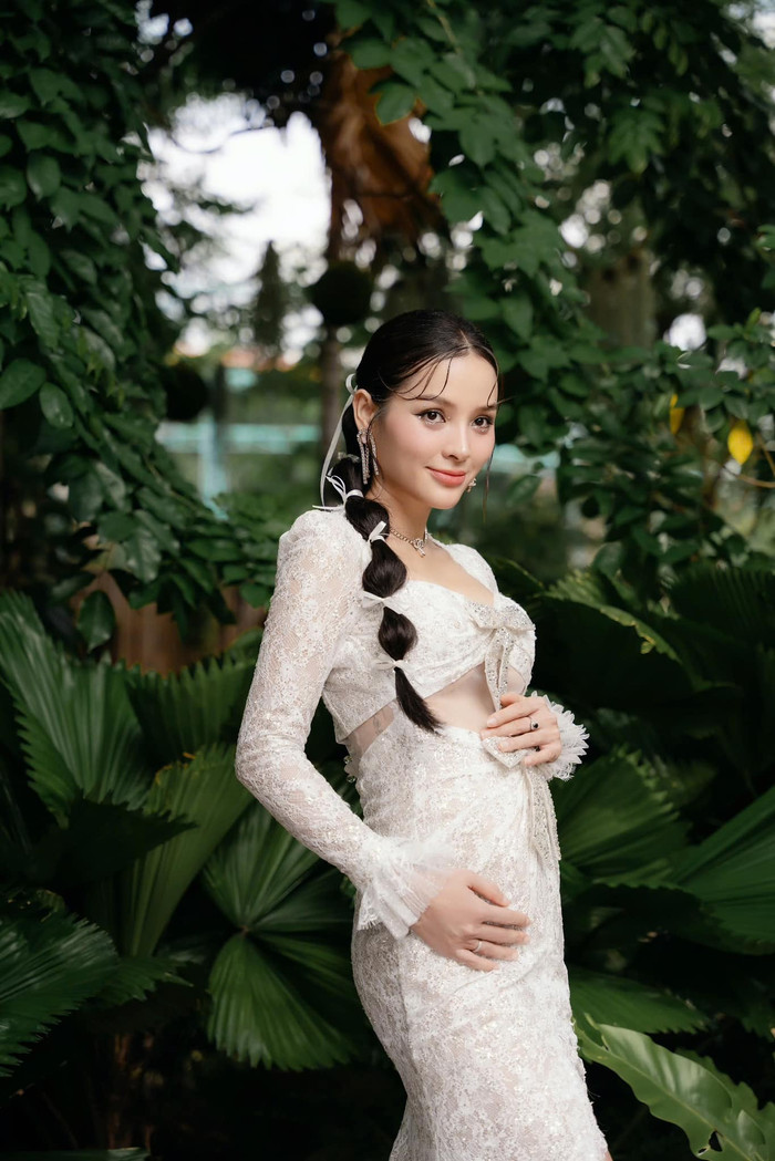 Nữ ca sĩ diện bộ váy ren trắng, có chi tiết cắt xẻ giúp khoe đường nét quyến rũ. 