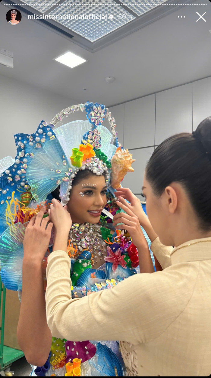 Hoa hậu Thanh Thủy hỗ trợ cho bạn thi cùng điều chỉnh trang phục trước khi lên sân khấu. Hành động của chân dài quê Đà Nẵng nhận được nhiều khen ngợi từ phía công chúng quê nhà. 