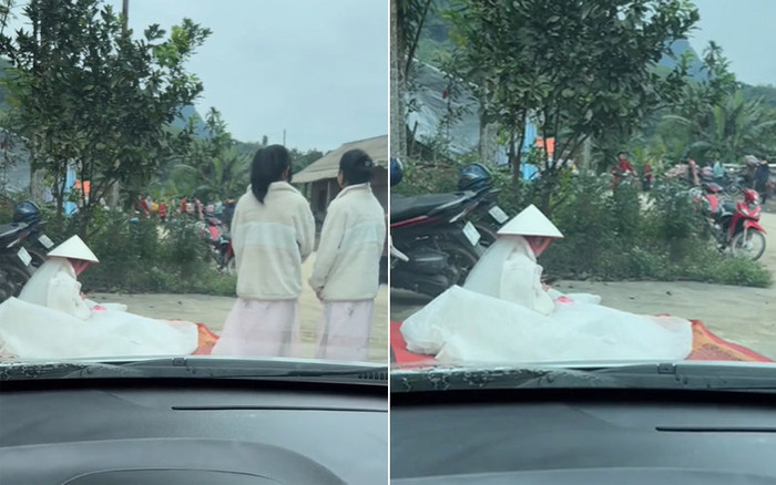 Hình ảnh cô dâu đội nón, ngồi ở ven đường. (Ảnh cắt từ video)