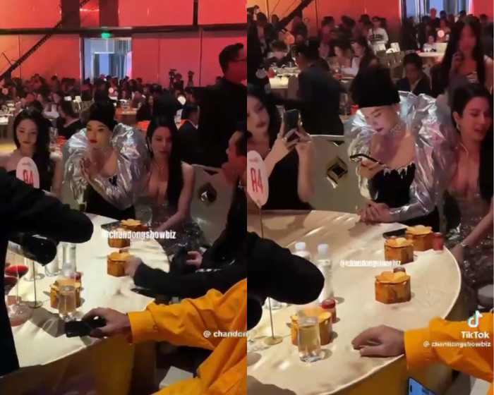 Hương Giang lấy điện thoại chụp ảnh Diệp Lâm Anh và chồng cũ. Trong khi đó, Kỳ Duyên nắm chặt tay đàn chị. (Ảnh chụp màn hình từ kênh Chấn động showbiz)