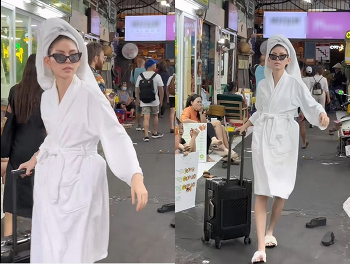 Nữ người mẫu tự tin quấn khăn tắm ra đường. (Ảnh chụp màn hình từ TikTok Tyhd Thùy Dương)