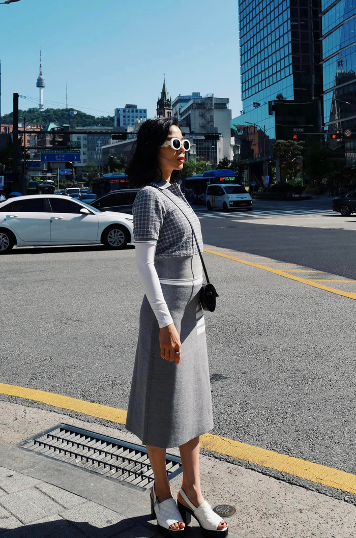 Nữ ca sĩ diện trang phục thanh lịch, kết hợp túi xách hiệu và mắt kính.