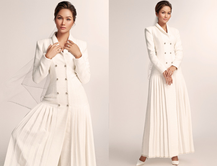 H'Hen Niê lăng xê mẫu váy cưới với phong cách khá cá tính. Phần thân trên là vest và phần thân dưới là váy dài nếp gấp, tuy khác biệt nhưng khi kết hợp lại thì hài hòa một cách khó tả. Thậm chí, nhiều người còn nhận xét khi nhìn H'Hen Niê trong bức ảnh này vừa mang cảm giác quyến rũ, nhưng cũng khá nam tính.