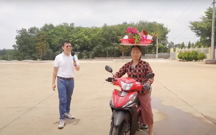 Chị vừa đội vừa đi xe máy