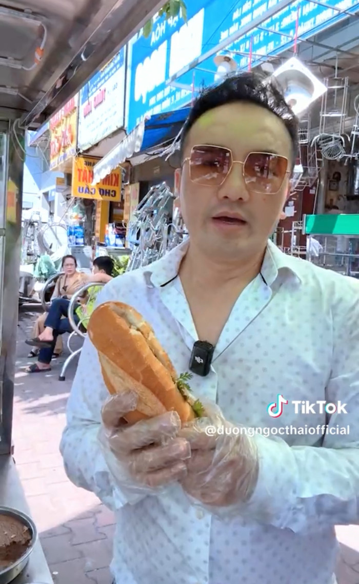 Nam ca sĩ mở xe bánh mì chay ở vỉa hè.