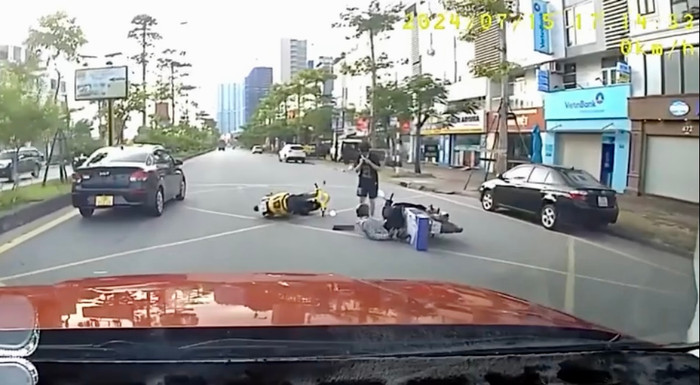 Tại một ngã tư, thanh niên này va chạm với một chiếc xe máy khác khiến cả hai ngã xuống đường.