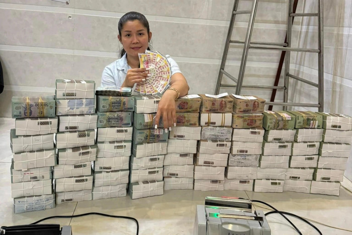 Hình ảnh người phụ nữ bên ngồi bên nhiều cọc tiền cùng các tờ vé số khiến dân tình ngỡ rằng, chị chính là chủ nhân của 12 tờ vé số giải đặc biệt.