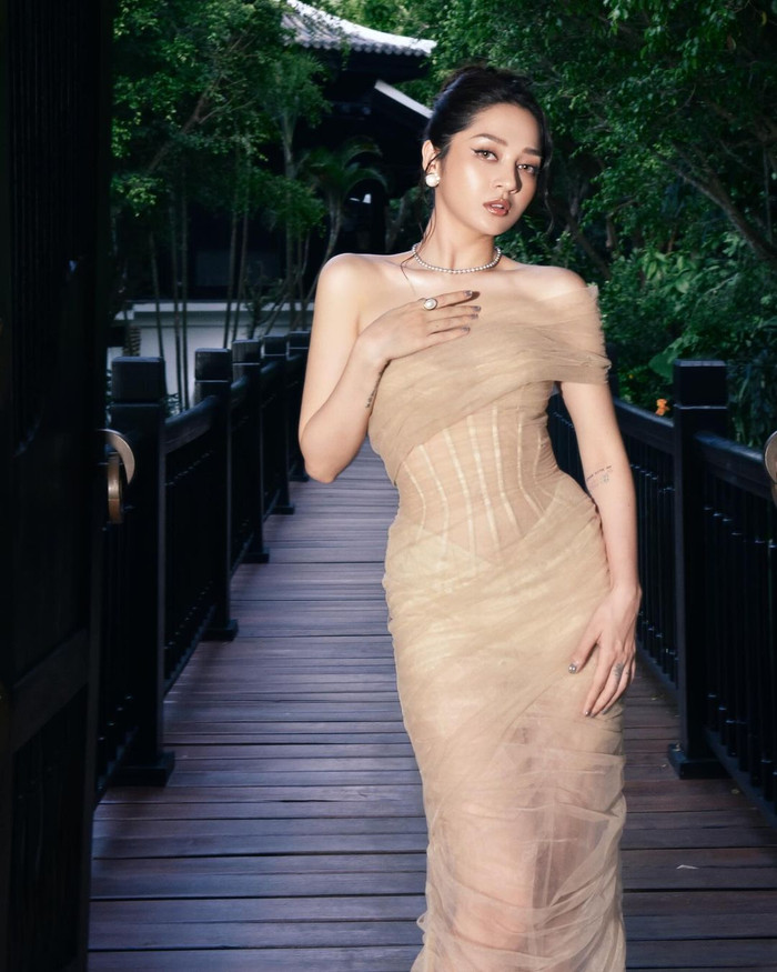 Bảo Anh xuất hiện với giao diện tựa 'búp bê Latinh' trong layout trang điểm đậm, theo tông nâu, điểm nhấn là đôi môi màu nude quyến rũ. Giọng ca Như lời đồn còn khoe khéo thân hình nóng bỏng, vòng nào ra vòng đó khi diện bộ cánh ôm sát, chất liệu mỏng manh, xuyên thấu. Thiết kế này còn được thiết kế bất đối xứng ở phần cầu vai, để lộ đường xương quai xanh sắc nét của Bảo Anh.