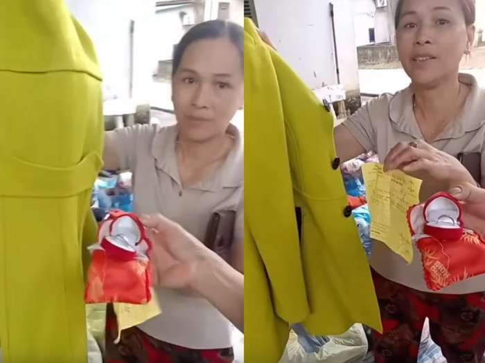 Chị Yến nhặt được nhẫn vàng trong lúc soạn quần áo của người dân gửi ủng hộ đồng bào vùng lũ. Ảnh: Cắt từ clip. 
